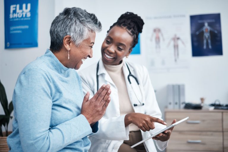 black,woman,,doctor,and,elderly,patient,with,good,news,,tablet